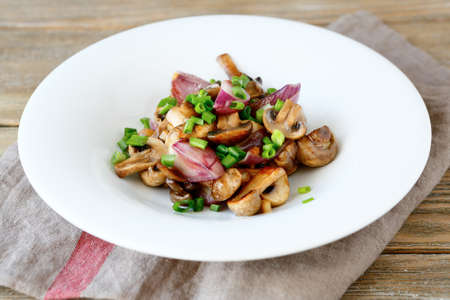Mushrooms and onions on a white plate, tasty foodの写真素材