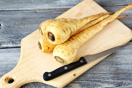 Raw Parsnip on a cutting board, vegetableの写真素材