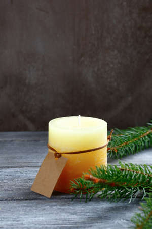 Christmas candle with pine branch on the boards, xmasの写真素材