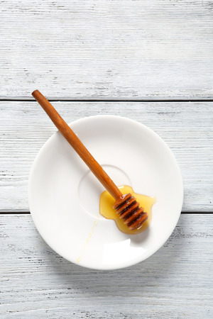 Stick in honey on a plate, dessertの写真素材