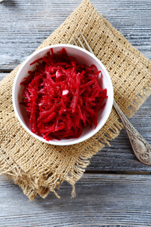Grated beet red in a bowl on napkin, foodの写真素材