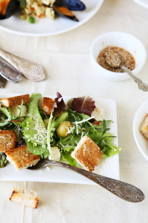 vegetable salad with croutons on white plateの写真素材