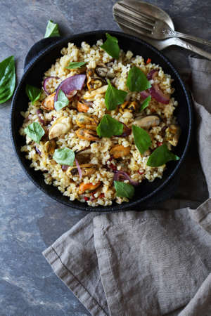 bulgur with mussels in pan, aboveの写真素材