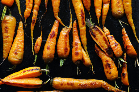 roast carrots on black tray, foodの写真素材