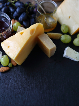 cheese and grapes on slate, food closeupの写真素材