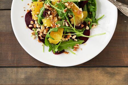 fresh salad with orange on plateの写真素材