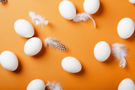 easter eggs and feathers background, food top viewの写真素材