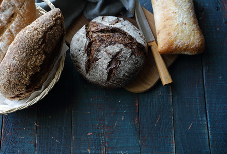 fresh breads on wooden background, food above