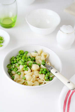 pasta with green peas in white bowl, fod close-upの写真素材