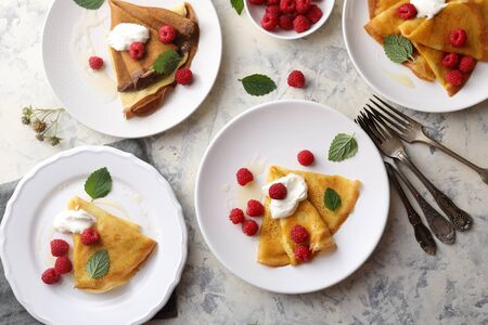 crepes with raspberry on white plates, food top viewの写真素材
