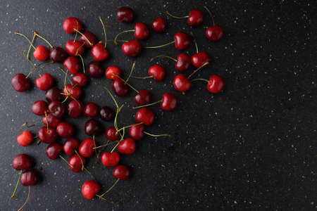 Muddy food background with cherries. Slateの写真素材