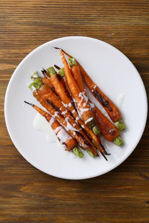 Organic roasted carrots with sauce, food top viewの写真素材