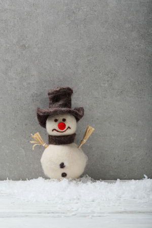 Wool snowman on concrete background, holiday decorの写真素材