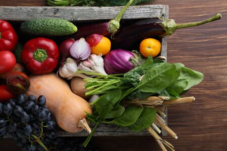 Harvest of veggies in wood crate, food ingredientsの写真素材