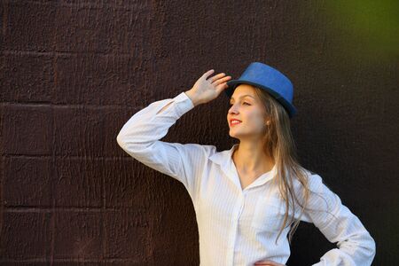 Beautiful young woman looking away with hatの写真素材