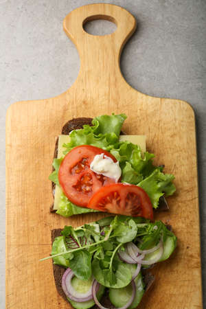 Breakfast sandwich on chopping board, cooking foodの写真素材