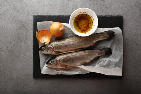 Raw trout fish on concrete, cooking