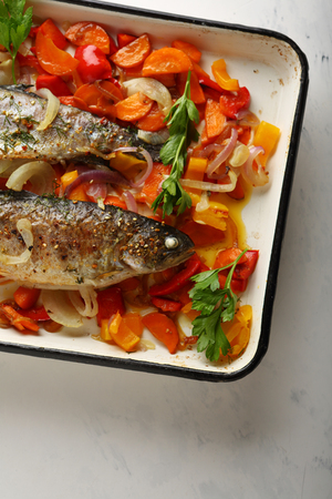 Fish with vegetables on baking tray, foodの写真素材