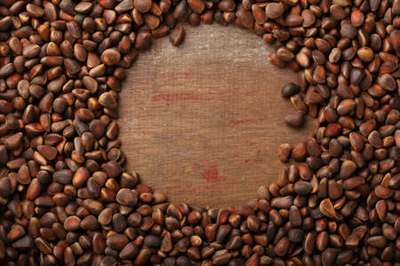 Fresh pine nuts wood backdrop, food closeupの写真素材