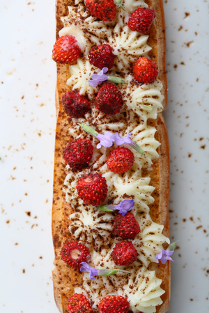 eclair with cream and strawberry, food above
