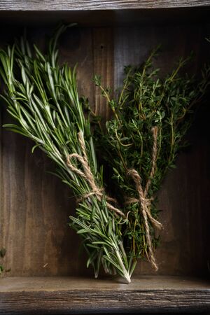 Bunches of Rosemary and thyme in crate, herbの写真素材