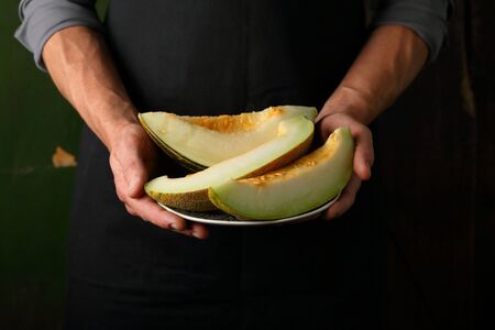 Fresh melons in hands, food closeupの写真素材