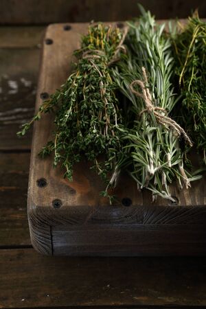 Fresh Rosemary and thyme on wood crateの写真素材