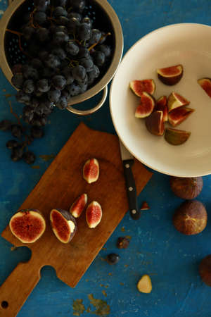 Fresh figs and grapes on wood, food flat layの写真素材