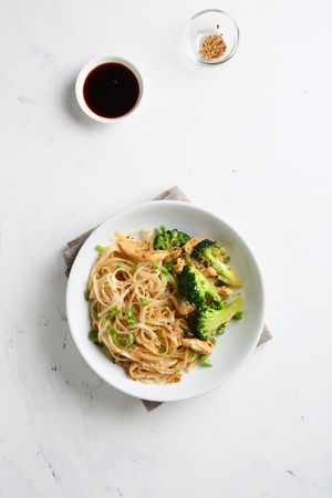 Udon Noodles with broccoli and meat, food top viewの写真素材