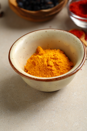 Yellow turmeric powder, spice closeupの写真素材