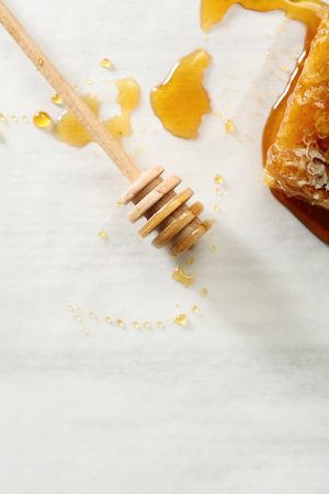 Golden honey in comb composition, food backgroundの写真素材