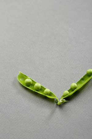 Green pea pods on gray backgroundの写真素材