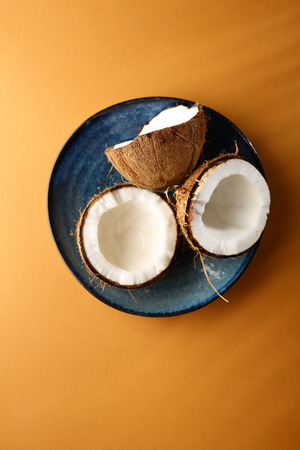 Fresh coconuts on yellow backdropの写真素材