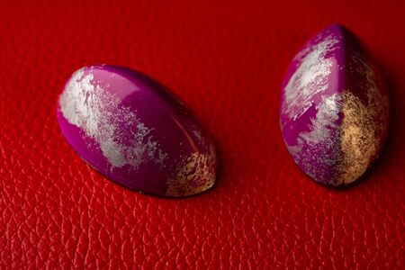 Sweet and beautiful chocolate bonbons  on red