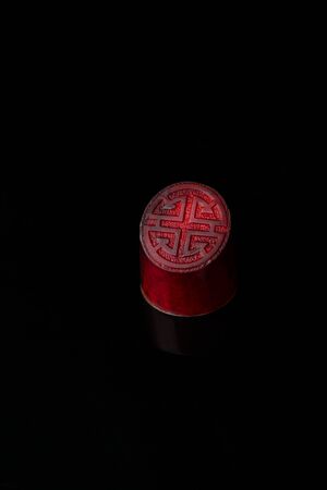 One red candy on dark backgroundの写真素材