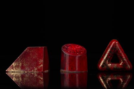 Red exclusive chocolate bonbons on blackの写真素材
