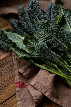 Fresh kale leaves on wooden boards
