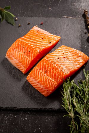 Fresh fish steak and spice on slateの写真素材