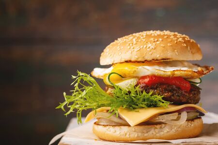 Gourmet burger with beef on wooden backgroundの写真素材