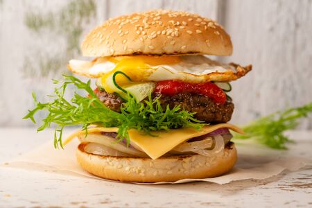 Gourmet burger with beef on white wooden backgroundの写真素材