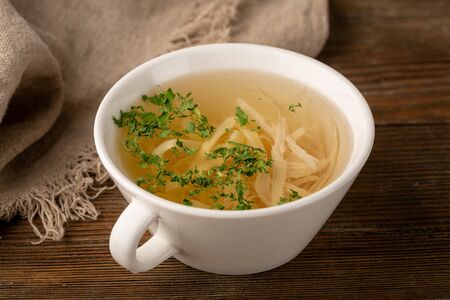 Bouillion with noodles and white meat close-upの写真素材