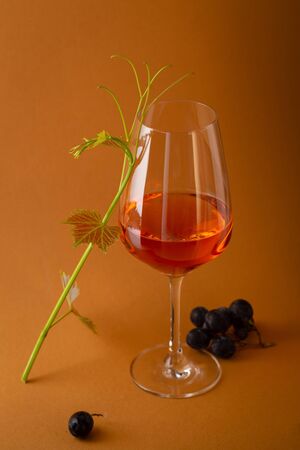Wine in glass and grapes branchの写真素材