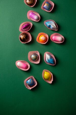 Green Background with chocolate bonbon collectionの写真素材