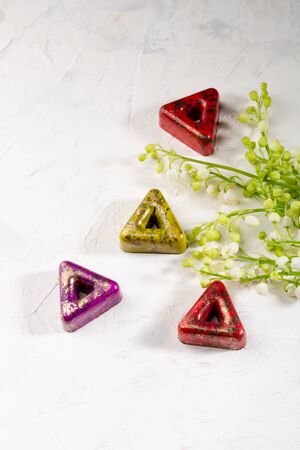 Chocolate bonbons set and flowers on white backgroundの写真素材