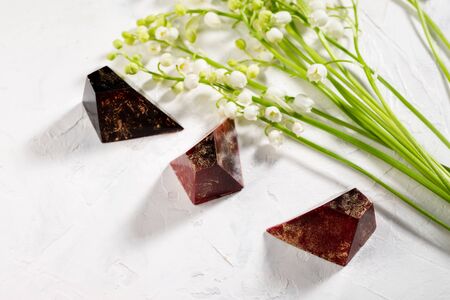 Chocolate bonbons and flowers on white backgroundの写真素材