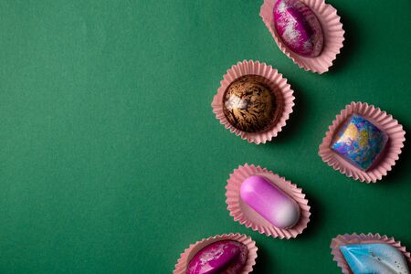 Green Background with chocolate bonbon collection top viewの写真素材