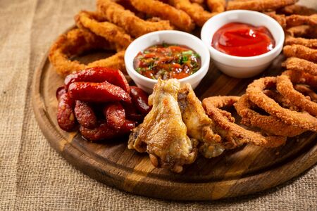 Salted rings and wings  pub platter with sauceの写真素材