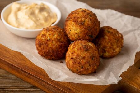 Falafel close-upl and white sauce on woodの写真素材