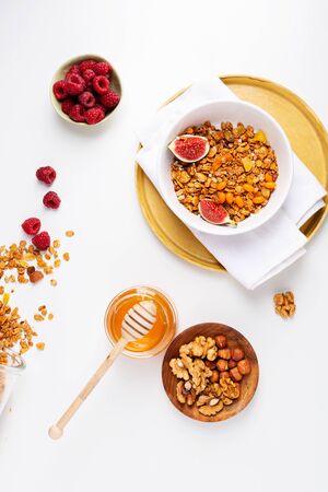 Granola  with berry and nuts on white tableの写真素材