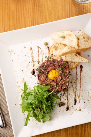 Beef Tartar with eggs with toasted breadの写真素材
